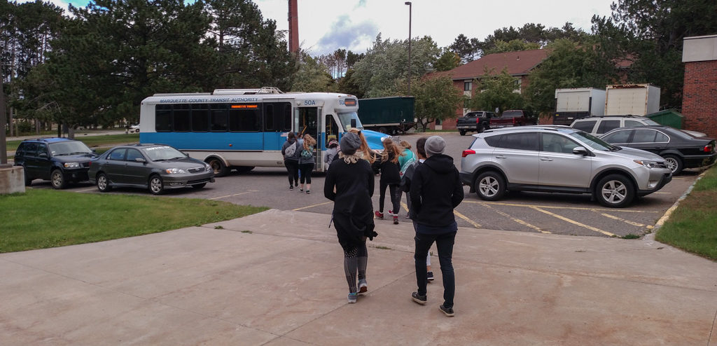 Students walking out the Marq-Tran bus at Lot #9 on NMU's Campus.