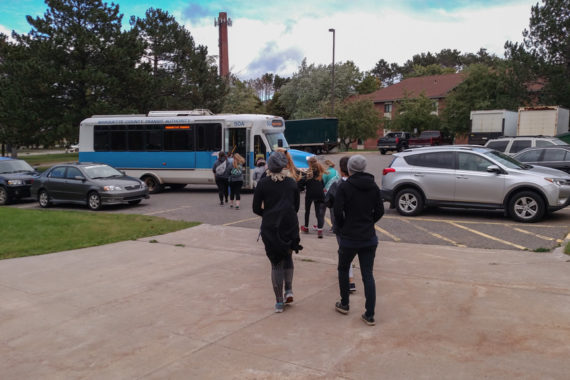Students walking out the Marq-Tran bus at Lot #9 on NMU's Campus.